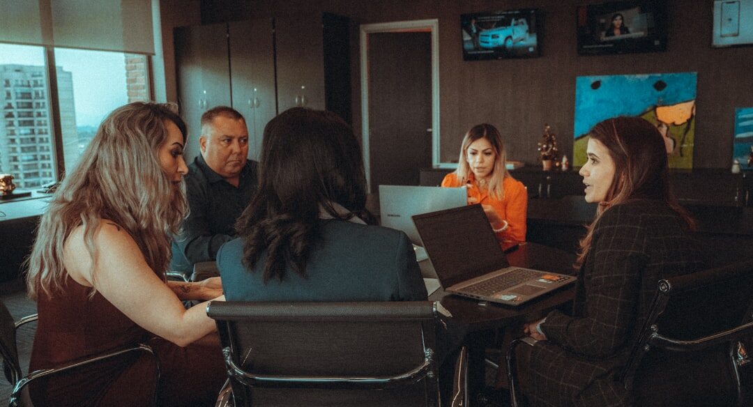 Team of Mexican insurance professionals working together in a modern office